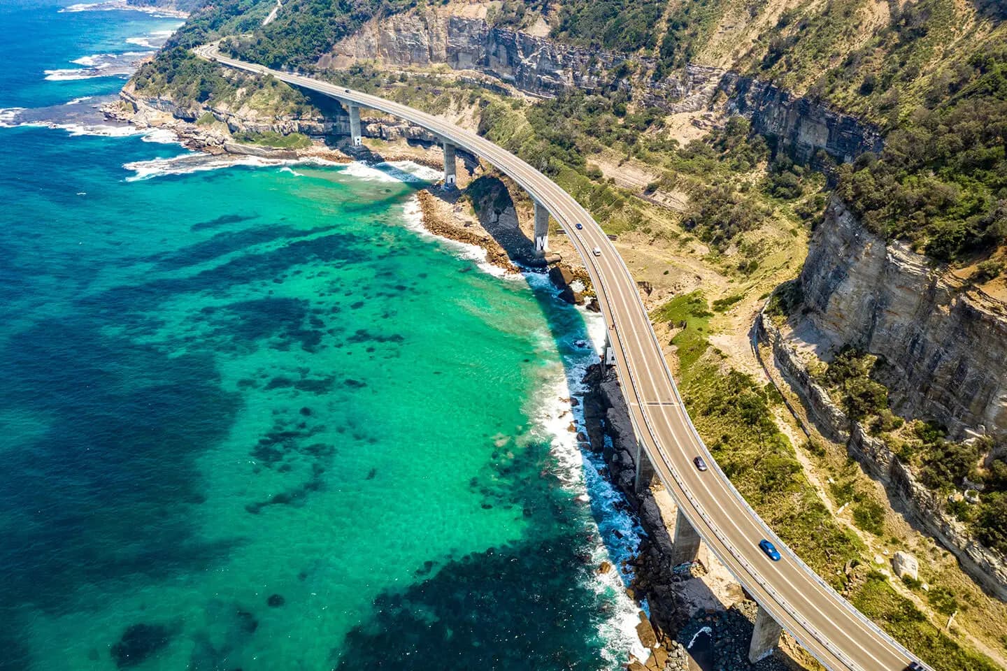 The Sea Cliff Bridge curving around the coast on the Grand Pacific Drive